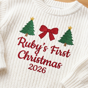 Close-up of machine embroidered first Christmas with trees & bow on chunky knit