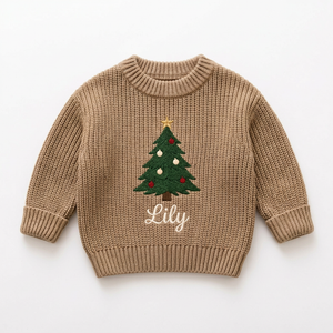 Machine embroidered big Christmas tree baby Christmas sweater on a plain background
