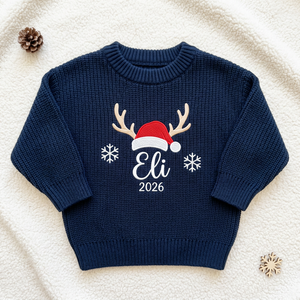 Machine embroidered reindeer antlers & Santa hat with year baby Christmas sweater, flat lay