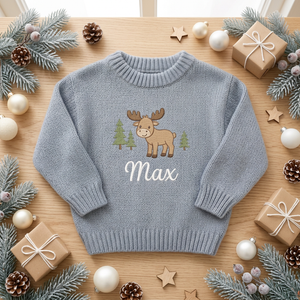 Machine embroidered moose & Christmas trees baby Christmas sweater among Christmas decorations