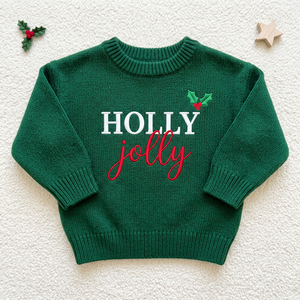 Machine embroidered Holly Jolly baby Christmas sweater, flat lay
