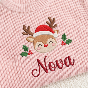 Close-up of machine embroidered baby reindeer with Santa hat on chunky knit