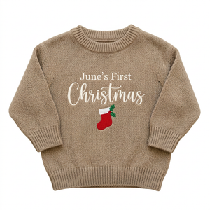 Machine embroidered first Christmas stocking baby Christmas sweater on a plain background