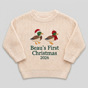Machine embroidered first Christmas ducks baby Christmas sweater on a plain background