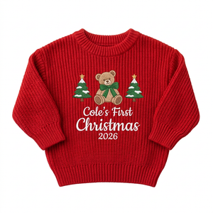 Machine embroidered first Christmas teddy bear baby Christmas sweater on a plain background