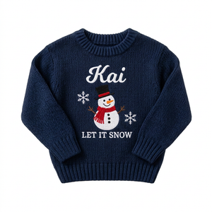 Machine embroidered snowman Let It Snow baby Christmas sweater on a plain background