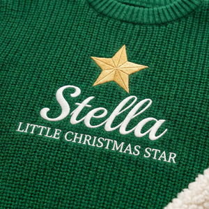 Close-up of machine embroidered little Christmas star on chunky knit