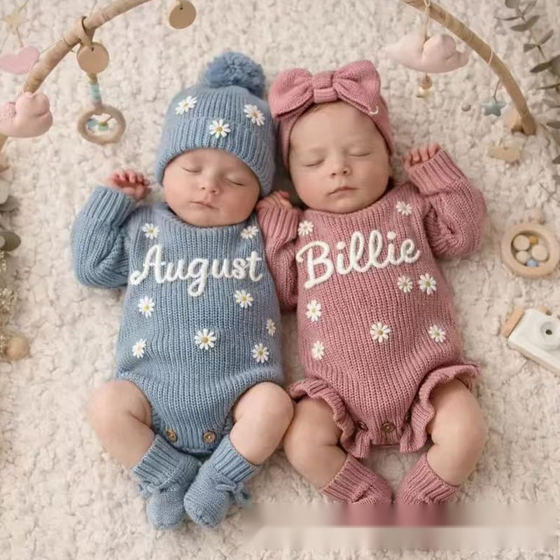 Two babies in knit rompers embroidered with August and Billie