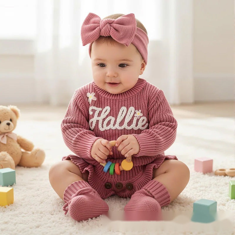 Baby girl in a rose pink knit romper with an embroidered name