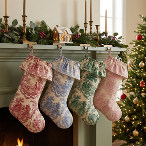 Personalized toile Christmas stockings with ruffled toile cuff hanging by the fireplace